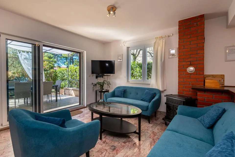 Living room with blue sofas and a dining table